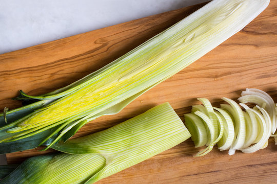 Close up of leeks on wooden cutting board