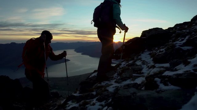 Silhouette couple spending vacation hiking sunrise Lake Wakatipu