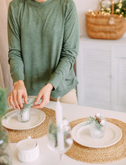 woman kitchen decorates Christmas table hands process