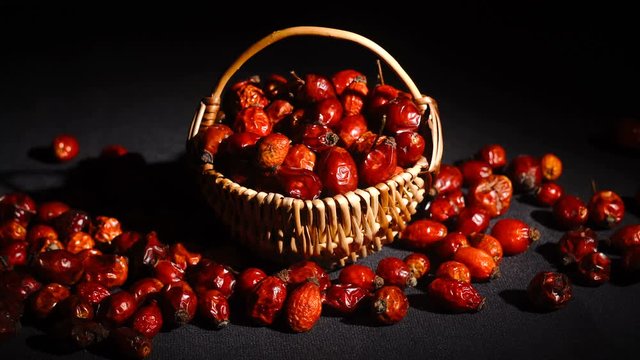 Detail macro view of dog rose hips in wicker basket latin name Fructus cynosbati . Dried rose hips are important source of vitamins in alternative medicine.