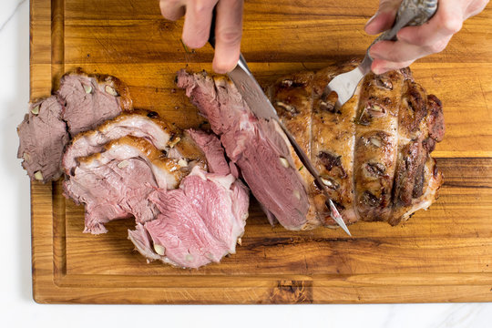 Overhead view of French lamb gigot being cut