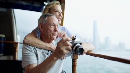 Taking travel pictures senior couple Hong Kong Asia - Powered by Adobe