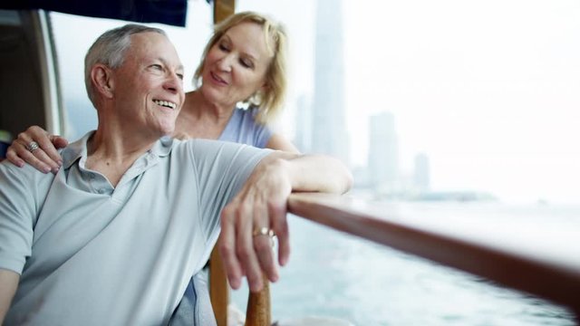 Relaxed happy couple viewing Victoria harbor Hong Kong