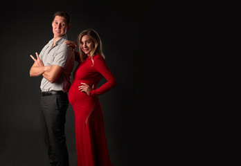 pregnant woman leaned on her man. They make fun of each other