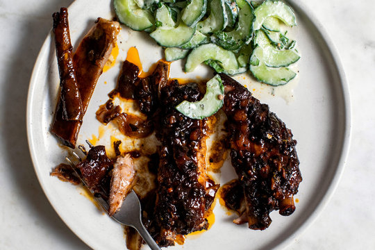Overhead view of sweet and spicy ribs with cucumber&dagger;raita