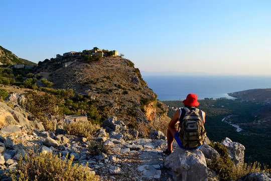 Tourist looking at the sea and old village in albanian mountains.