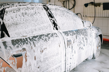 Gray car at the sink in the foam