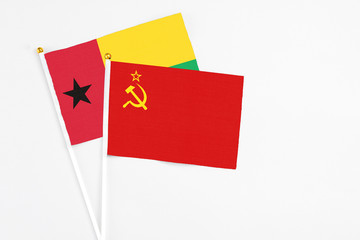 Soviet Union and Guinea Bissau stick flags on white background. High quality fabric, miniature national flag. Peaceful global concept.White floor for copy space.