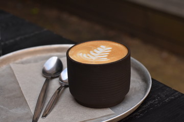 cup of coffee on wooden table