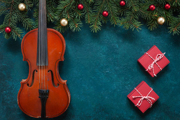 Old violin and fir-tree branches with Christmas decor. Christmas, New Year's concept. Top view,...