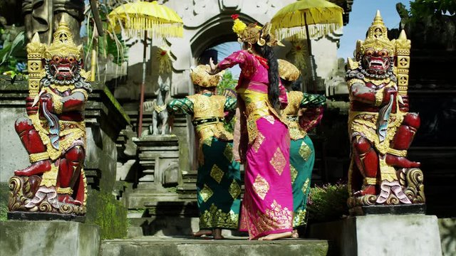 Females performing ancient religious dance ritual Hindu temple 