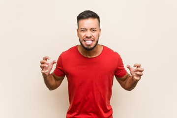 Young south-asian man screaming with rage.