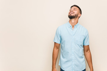 Fototapeta premium Young south-asian man relaxed and happy laughing, neck stretched showing teeth.