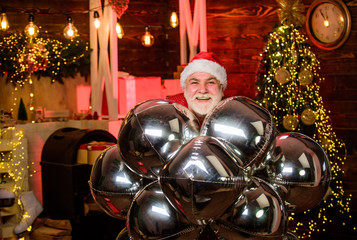 Fototapeta premium lets celebrate. party decoration. bearded man santa claus hat. winter holiday celebration. merry christmas. happy new 2020 year. xmas gifts and presents. cheerful santa man party balloons