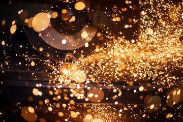 Metal cutting. Sparks from processing a metal profile.