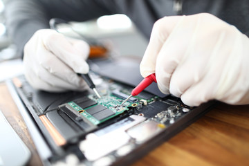 Technician soldering laptop board