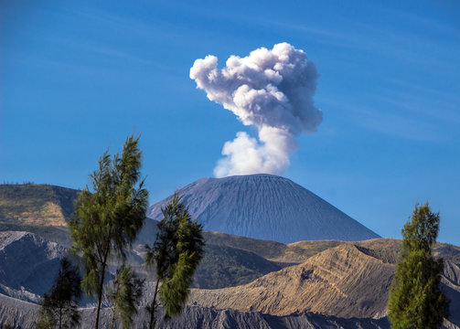 Indonesia - East Java - The column of smoke rising above the vent of an active volcano Semeru with Bromo caldera on a foreground