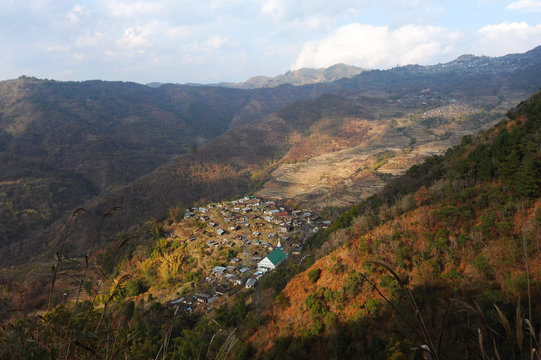 View across Naga hills over small Naga village, terraced ricefields and farmland, Nagaland