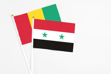 Syria and Guinea stick flags on white background. High quality fabric, miniature national flag....
