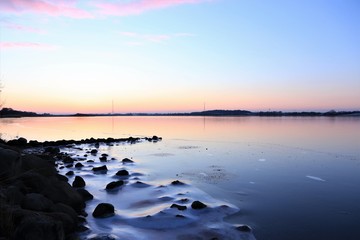 frozen river with pastel colored sky, funeral home, loss