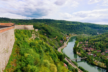 Fototapeta na wymiar Citadel in Besancon and River Doubs in Bourgogne Franche-Comte region of France. French Castle and medieval stone fortress in Burgundy. Fortress architecture and landscape. View from tower