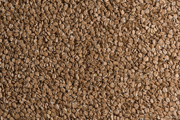 Chit wheat flakes grains background. Сereals for the production of alcoholic beverages and animal feed. Flat lay