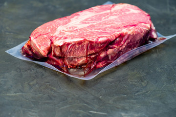 The marbled beef steak in a vacuum pack.