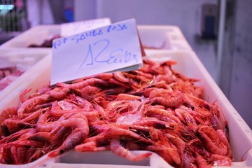Close-up of a box of fresh prawns at a fish market stall in the market