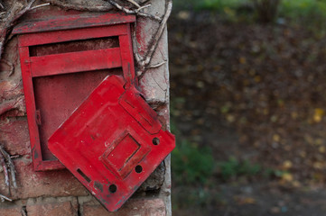 Red old mailbox on the wall. Letter boxes.