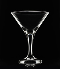 White silhouette of empty martini cocktail glass on a black background