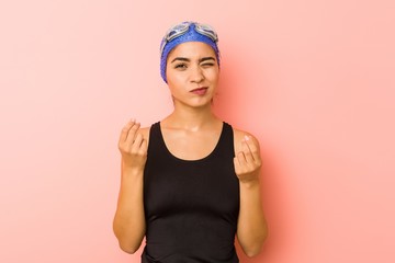 Young arab swimmer woman isolated showing that she has no money.