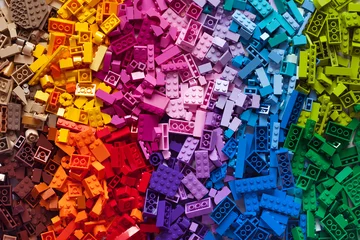 Rolgordijnen Lot of colorful rainbow toy bricks background. Educational toy for children. © Tatsiana