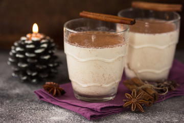 Christmas holiday cacao. Hot chocolate cacao drinks with decoration  in Christmas mugs on grey background. Traditional hot beverage, festive cocktail at X-mas or New Year
