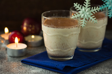 Christmas holiday cacao. Hot chocolate cacao drinks with decoration  in Christmas mugs on grey background. Traditional hot beverage, festive cocktail at X-mas or New Year