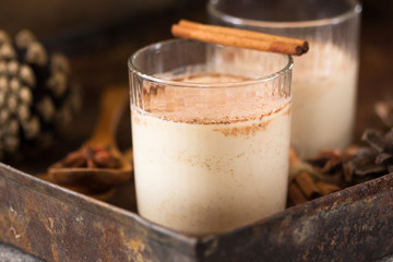 Christmas holiday cacao. Hot chocolate cacao drinks with decoration  in Christmas mugs on grey background. Traditional hot beverage, festive cocktail at X-mas or New Year