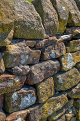 Stone wall. Abstract dry stones in boundary wall in Derbyshire Peak District countryside.  Stone material construction, natural and textured.