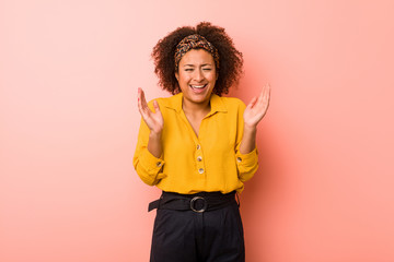 Young african american woman against a pink background joyful laughing a lot. Happiness concept.