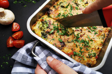 Hand cuting frittata with vegetables