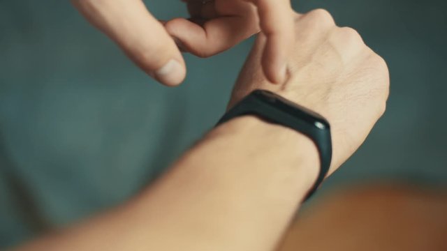 4k footage close up man using fitness tracker 