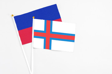 Faroe Islands and Haiti stick flags on white background. High quality fabric, miniature national...