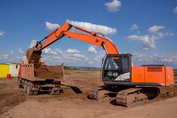 Fototapeta na wymiar Industrial excavator on a construction site. Special equipment on the background of the landscape