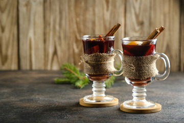 Mulled wine in glass glasses with apples, orange, cinnamon and star anise. Hot Christmas drink on a...