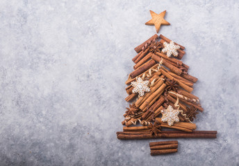Christmas tree made of cinnamon on grey background, space for text. X-mas or New year festive flat lay background