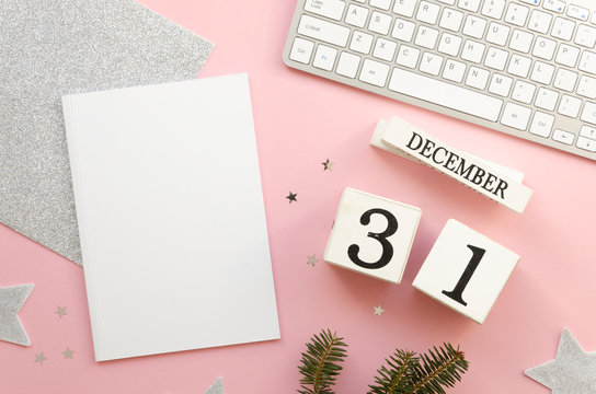 Blank notebook mockup. White wooden perpetual calendar cubes. Data 31 December. Keyboard and decorative branch on white background. Top view Flat lay Copy space.New year To do list concept