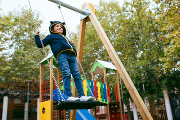 little boy smiling and playing in the park