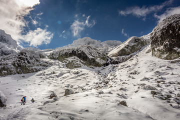 Two people staring in the amazing winter landscape at the Rila Mountain in Bulgaria, Maliovica.