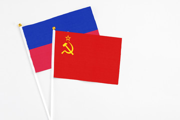 Soviet Union and Haiti stick flags on white background. High quality fabric, miniature national flag. Peaceful global concept.White floor for copy space.