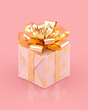 Christmas white gift box with glittering golden bow and ribbons. Snowflakes pattern on paper. Realistic 3D rendering.