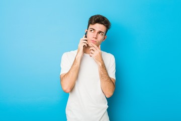 Teenager caucasian man talking on the phone