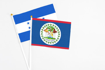Belize and Honduras stick flags on white background. High quality fabric, miniature national flag....
